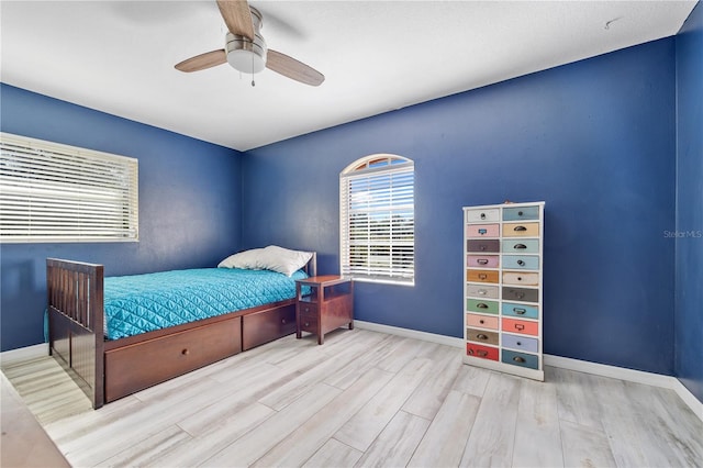 bedroom with ceiling fan and light wood-type flooring