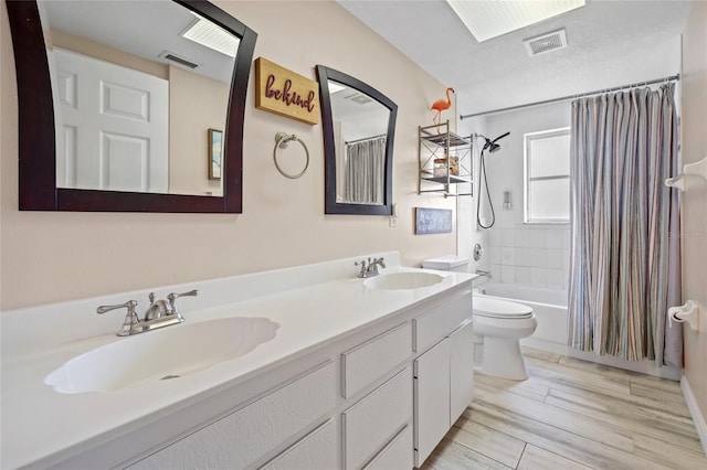 full bathroom featuring toilet, vanity, shower / bath combination with curtain, and wood-type flooring