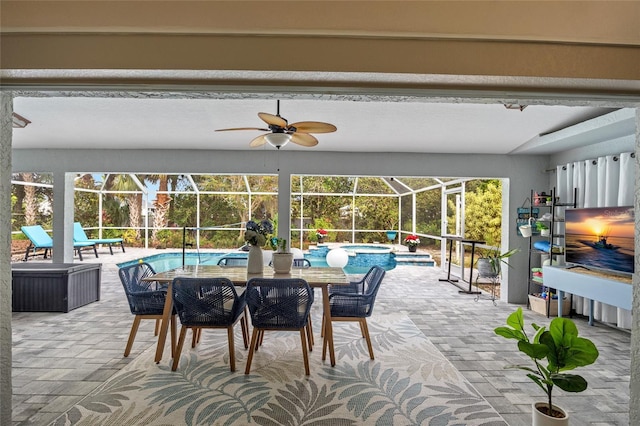 view of patio with glass enclosure, ceiling fan, and a pool with hot tub