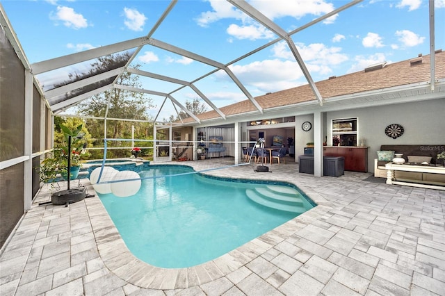 view of swimming pool featuring a lanai and a patio