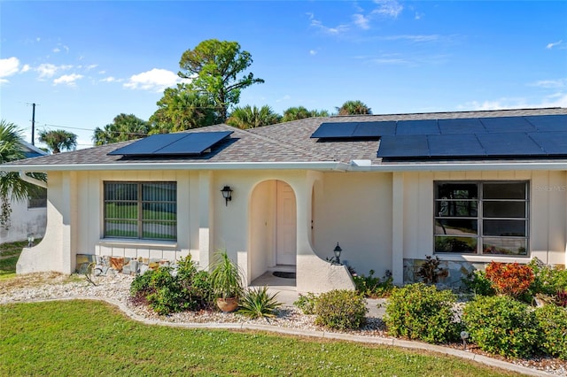 view of front facade with solar panels