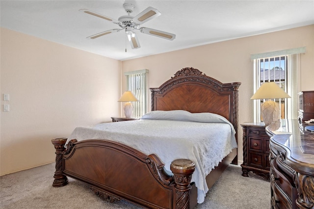 bedroom with ceiling fan and light colored carpet