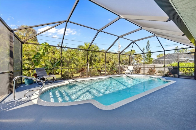 view of pool featuring glass enclosure and a patio area