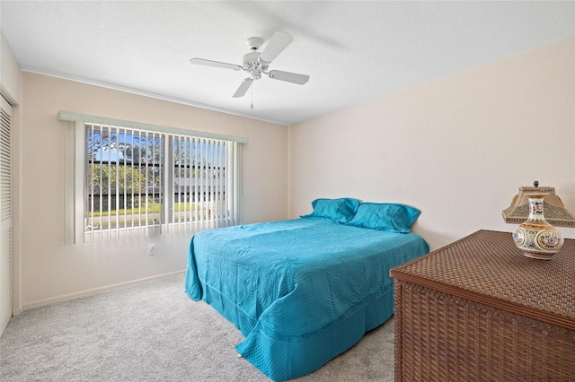 bedroom featuring light colored carpet and ceiling fan