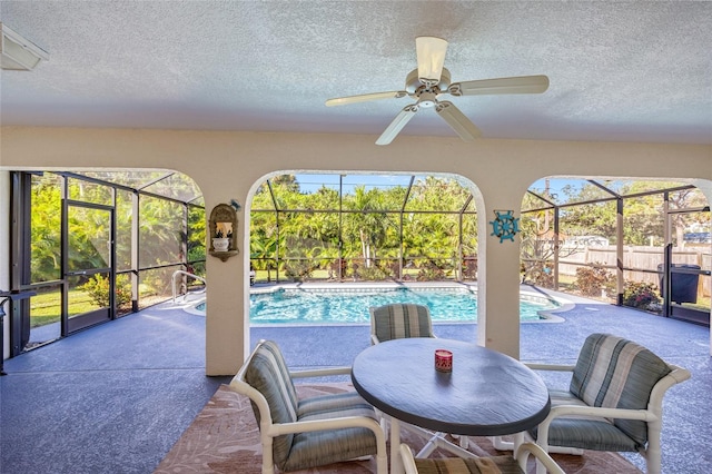 interior space with ceiling fan