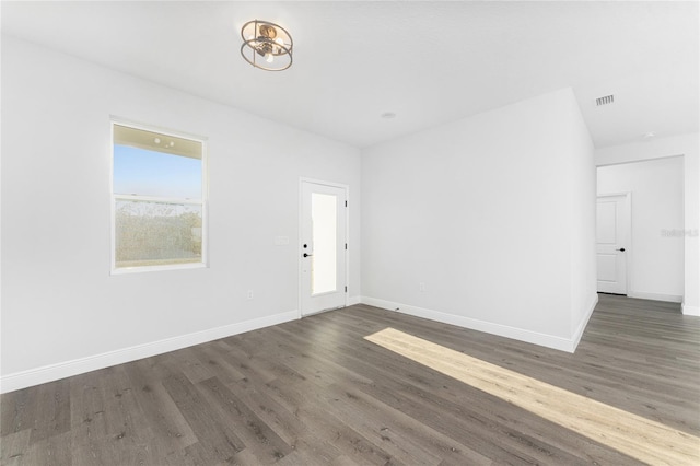 spare room with dark hardwood / wood-style floors