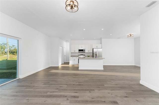 unfurnished living room featuring dark hardwood / wood-style floors