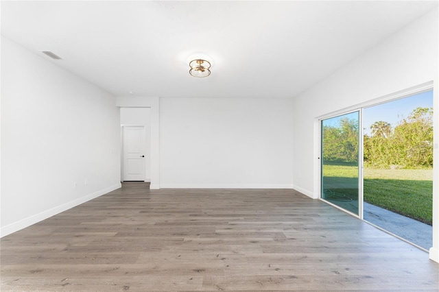 unfurnished room with wood-type flooring