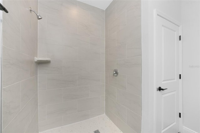 bathroom with a tile shower