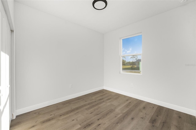 spare room with hardwood / wood-style floors