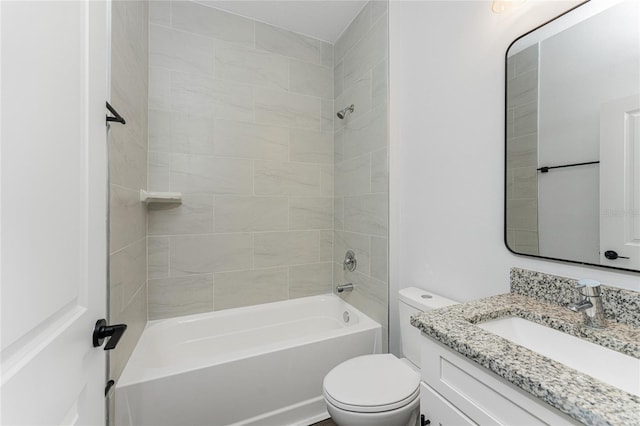 full bathroom with tiled shower / bath combo, toilet, and vanity