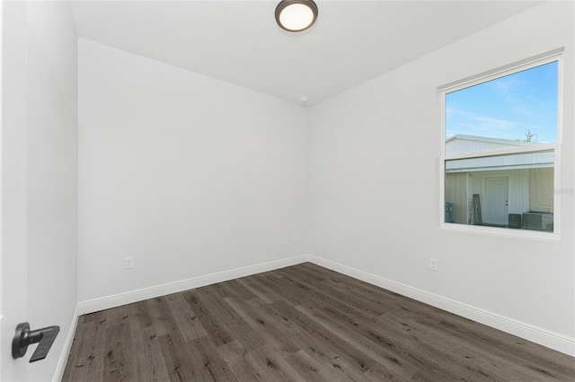 spare room featuring dark hardwood / wood-style floors