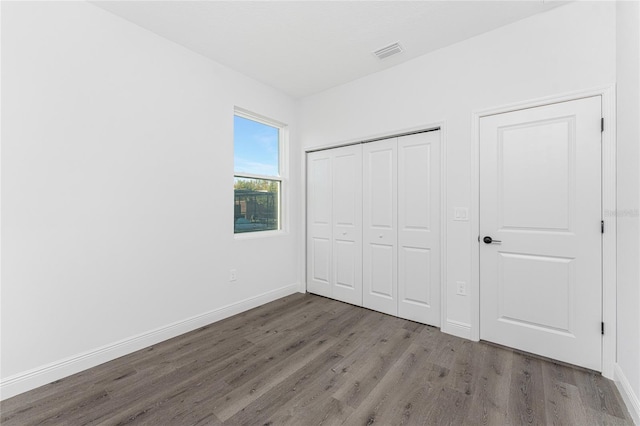 unfurnished bedroom with hardwood / wood-style floors