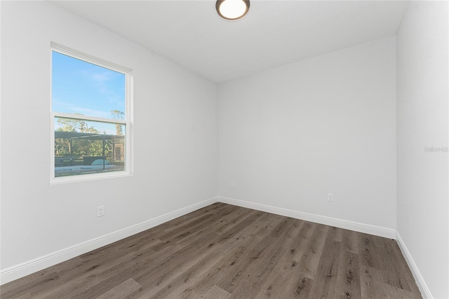 spare room with dark wood-type flooring