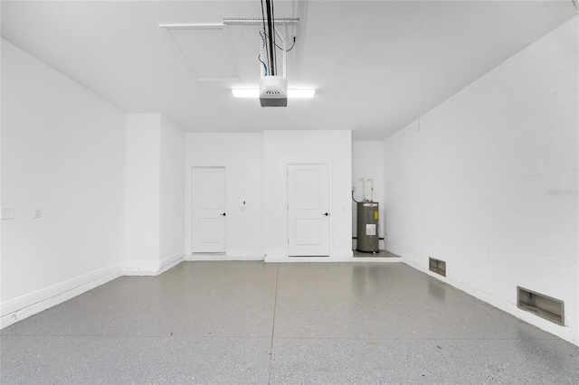 garage featuring water heater and a garage door opener