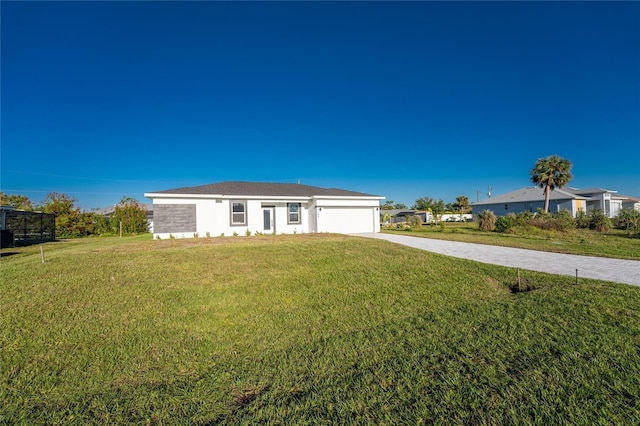 ranch-style house featuring a garage and a front yard