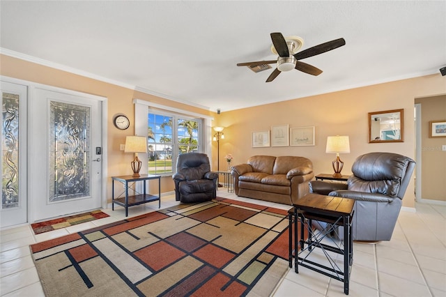 living room with ceiling fan, ornamental molding, and light tile patterned floors