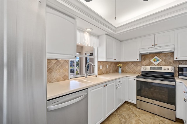 kitchen with backsplash, sink, white cabinets, and stainless steel appliances