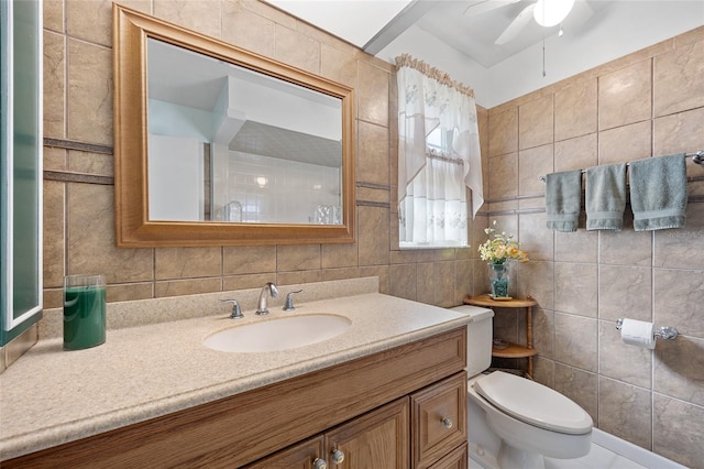 bathroom featuring backsplash, vanity, ceiling fan, tile walls, and toilet