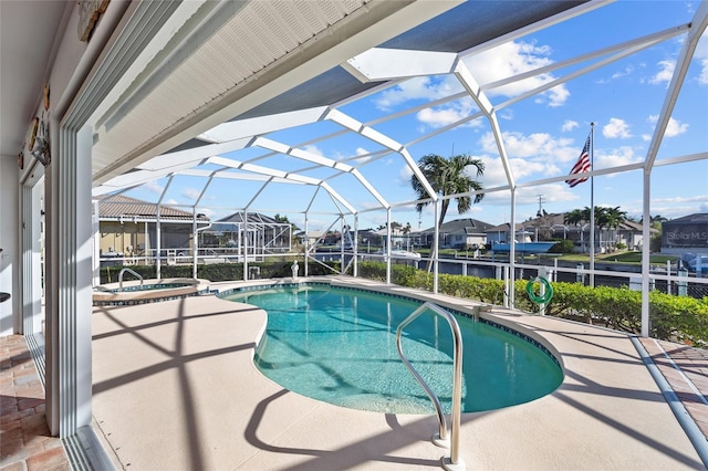 view of pool with glass enclosure and a patio area