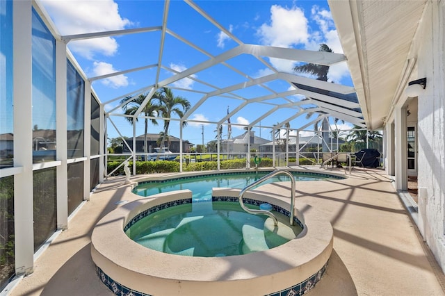 view of swimming pool featuring a lanai, an in ground hot tub, and a patio