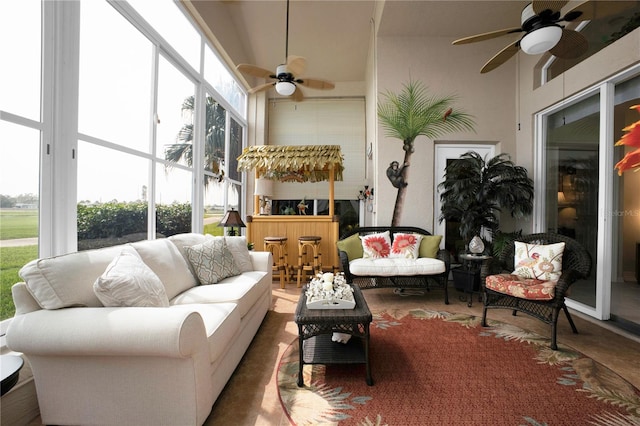 sunroom / solarium featuring plenty of natural light and ceiling fan