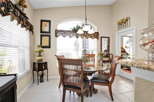 tiled dining space with a chandelier and plenty of natural light