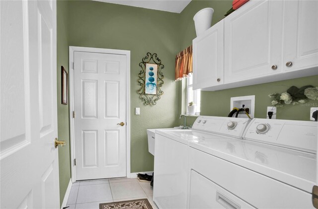 washroom with washer and clothes dryer, light tile patterned floors, cabinets, and sink