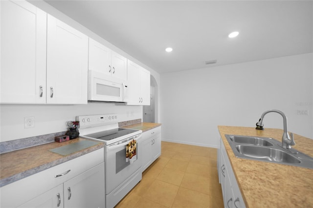 kitchen with white cabinets, white appliances, and sink