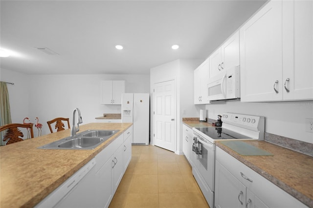 kitchen featuring light tile patterned floors, white appliances, white cabinetry, and sink