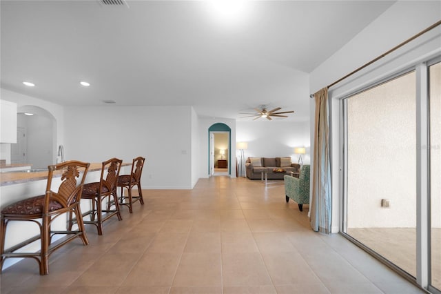 tiled dining space featuring ceiling fan