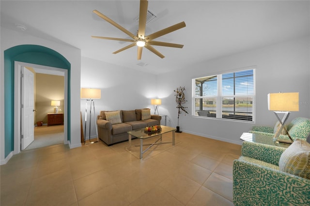 tiled living room featuring ceiling fan