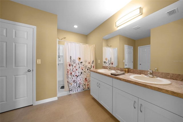 bathroom with a shower with shower curtain, vanity, and tile patterned floors