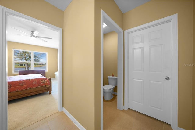 bathroom featuring tile patterned flooring, ceiling fan, and toilet