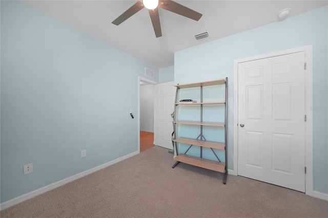 unfurnished bedroom featuring ceiling fan and light colored carpet