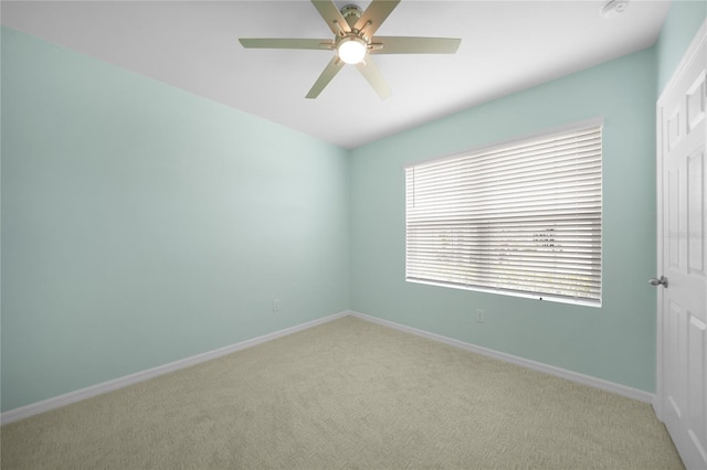 carpeted empty room with ceiling fan