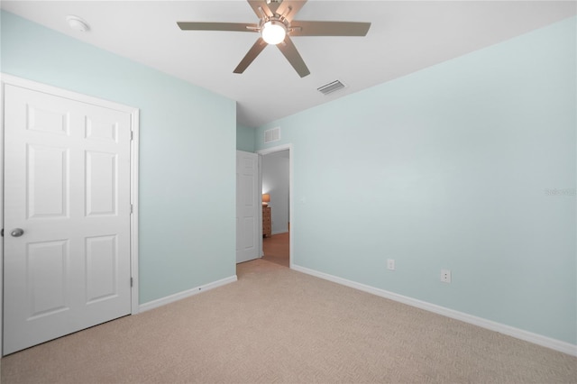 unfurnished bedroom featuring light colored carpet and ceiling fan