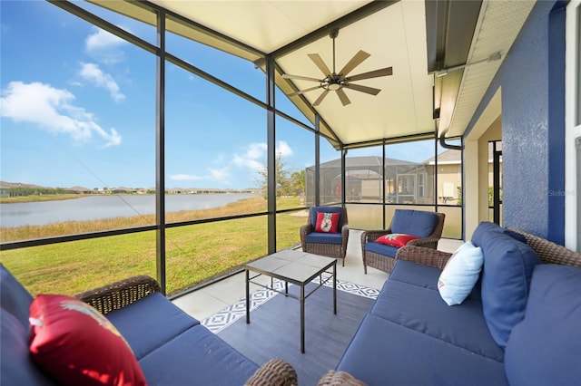 sunroom with a water view, vaulted ceiling, and ceiling fan