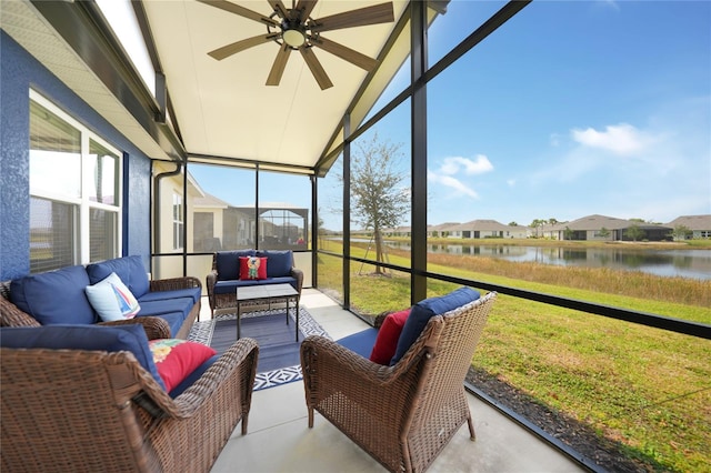 sunroom / solarium featuring a water view and ceiling fan