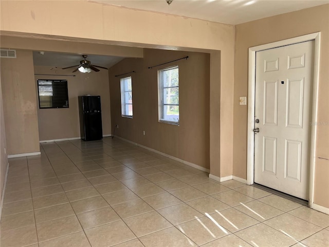 tiled entrance foyer featuring ceiling fan and vaulted ceiling