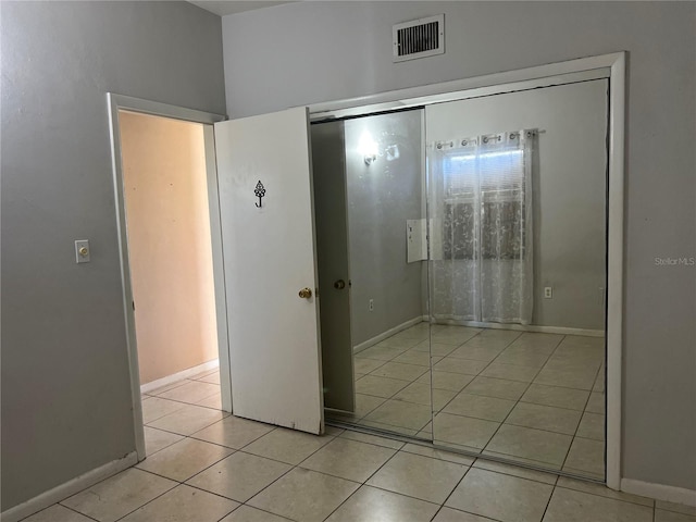 hall with light tile patterned floors