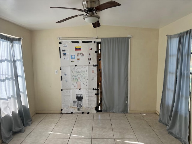 unfurnished room with light tile patterned floors, ceiling fan, and lofted ceiling