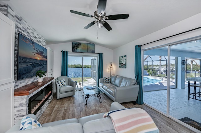 living room featuring hardwood / wood-style floors, vaulted ceiling, a wealth of natural light, and ceiling fan