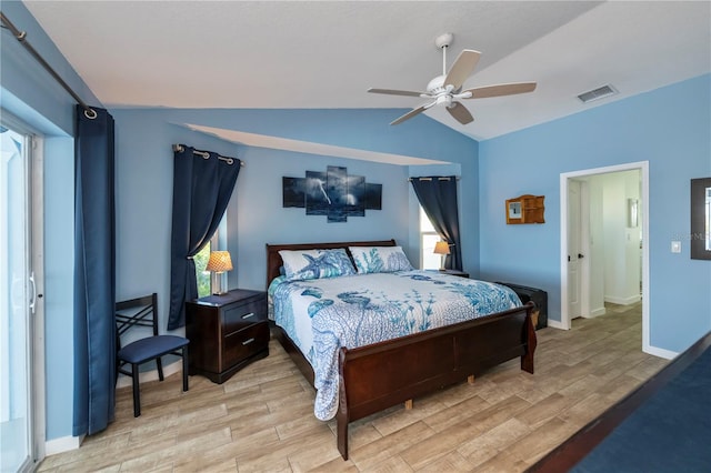 bedroom with ceiling fan, light hardwood / wood-style floors, and vaulted ceiling