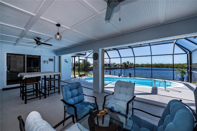 view of swimming pool featuring glass enclosure, a water view, an outdoor bar, and a patio