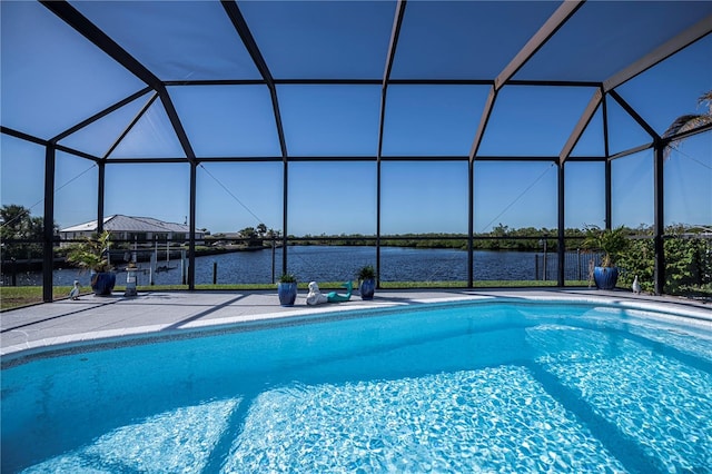 view of pool with a patio, a water view, and glass enclosure