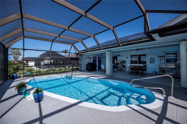 view of pool with a lanai, a patio area, and ceiling fan