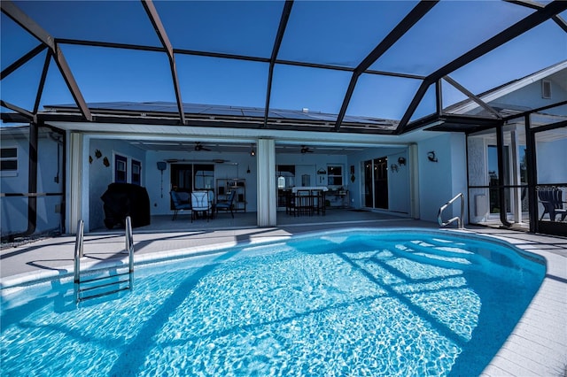 view of pool featuring a patio area, ceiling fan, and a lanai