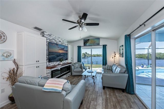 living area featuring lofted ceiling, dark wood-style floors, ceiling fan, and visible vents