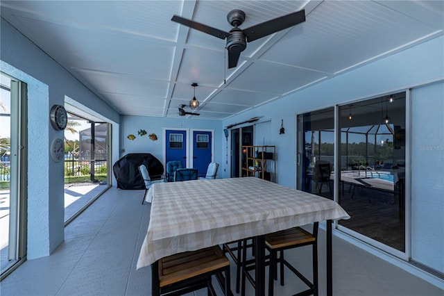 interior space featuring a sunroom, coffered ceiling, and a ceiling fan